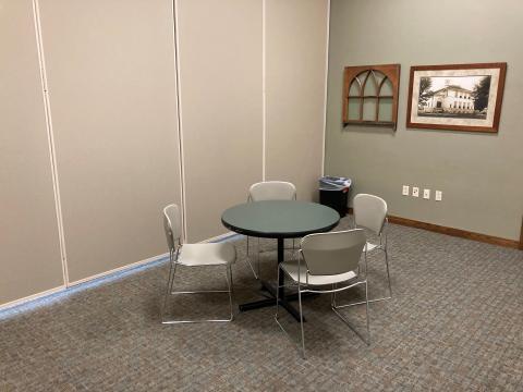 chairs around a table in small division of community room