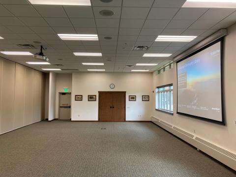 medium sized room with projector screen