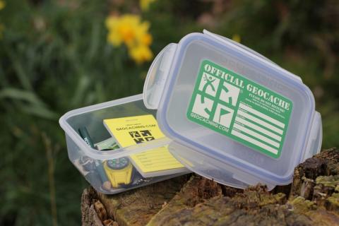 Plastic box outside with label saying Official Geocache