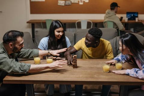 Four teens playing a board game.