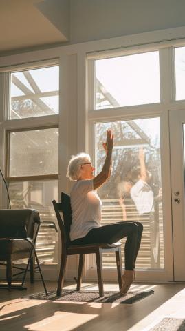 Woman sitting in chair with eagle arms yoga position.