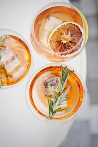 Image shows three orange-flavored mocktails.