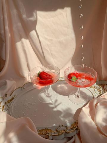 Image shows two strawberry-flavored cocktails.