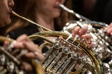 Image of a person playing a French horn