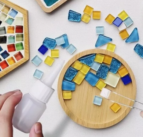 round wood coaster with different colored mosaic tiles